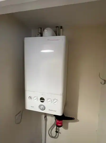 Boiler Supplier King's Lynn installing an Ideal Esprit Eco gas boiler with a magnetic system filter in a modern home.