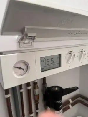 New boiler cost in King's Lynn – close-up of a modern combi boiler control panel with pressure gauge, digital display and magnetic filter installed by Delta Gas Installations.